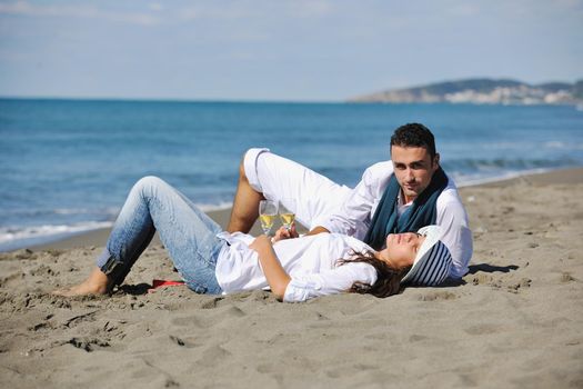 happy young couple enjoying  picnic on the beach and have good time on summer vacations