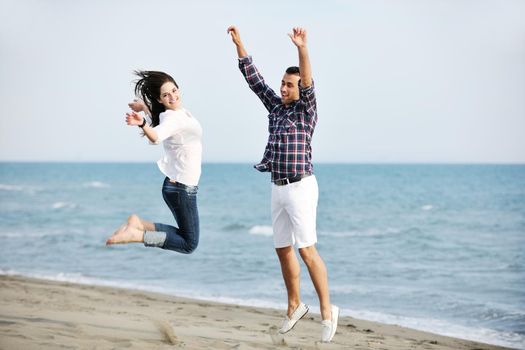 happy young couple have fun and romantic moments on beach at summer season and representing happynes and travel concept