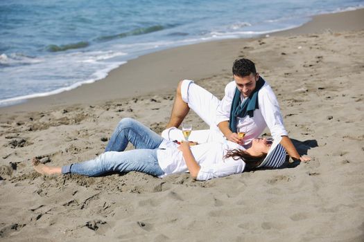 happy young couple enjoying  picnic on the beach and have good time on summer vacations