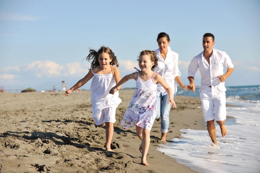 happy young family in white clothing have fun at vacations on beautiful beach 