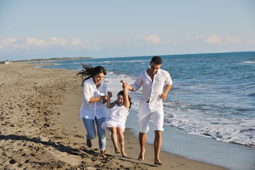 happy young family in white clothing have fun at vacations on beautiful beach 