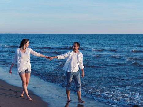 happy young romantic couple in love have fun on beautiful beach at beautiful summer day