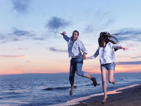 happy young romantic couple in love have fun on beautiful beach at beautiful summer day