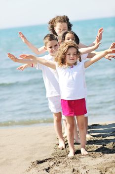 group of happy child on beach who have fun and play games