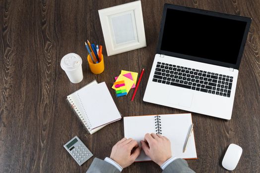 view from above of the businessman's workplace. Laptop and stationery on the table