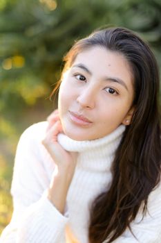 Portrait of japanese woman sitting outdoors. Concept of asian female person and beauty.