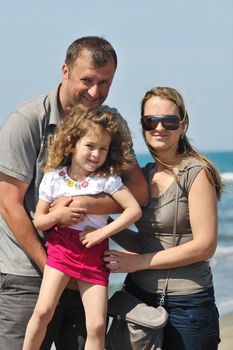 happy young family have fun and live healthy lifestyle on beach