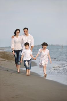 happy young family have fun and live healthy lifestyle on beach