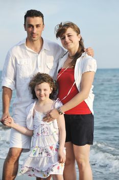 happy young family have fun and live healthy lifestyle on beach