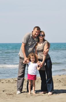 happy young family have fun and live healthy lifestyle on beach