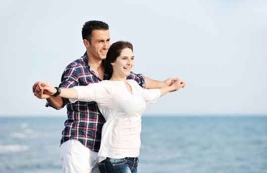 happy young couple have fun and romantic moments on beach at summer season and representing happynes and travel concept