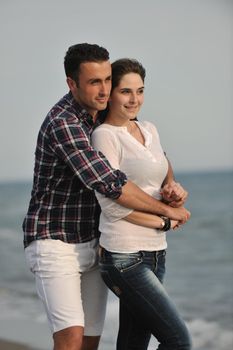 happy young couple have fun and romantic moments on beach at summer season and representing happynes and travel concept