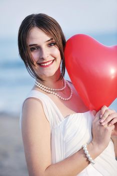 happy just married young couple celebrating and have fun at beautiful beach sunset