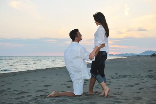 happy young couple have fun and romantic moments on beach at summer season and representing happynes and travel concept