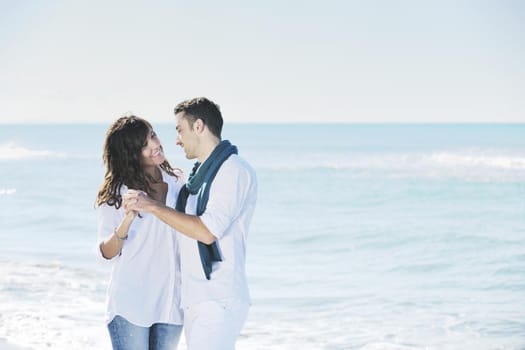 happy young couple in white clothing  have romantic recreation and   fun at beautiful beach on  vacations