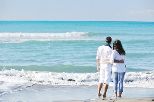 happy young couple in white clothing  have romantic recreation and   fun at beautiful beach on  vacations