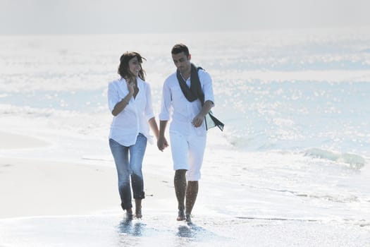 happy young couple in white clothing  have romantic recreation and   fun at beautiful beach on  vacations