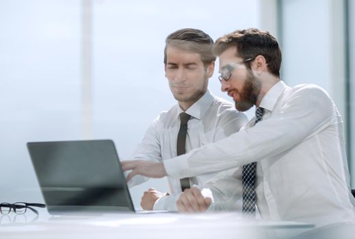 two business colleagues discuss the information sitting at the Desk . photo with copy space