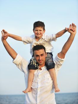 happy young family have fun and live healthy lifestyle on beach