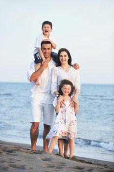 happy young family have fun and live healthy lifestyle on beach