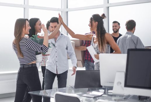 happy business team in new office.the concept of moving