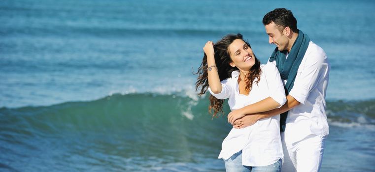 happy young couple in white clothing  have romantic recreation and   fun at beautiful beach on  vacations