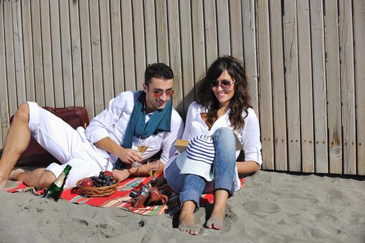 happy young couple enjoying  picnic on the beach and have good time on summer vacations