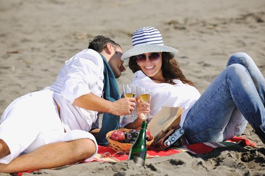 happy young couple enjoying  picnic on the beach and have good time on summer vacations