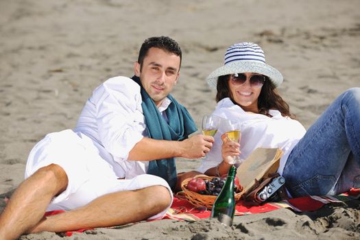 happy young couple enjoying  picnic on the beach and have good time on summer vacations