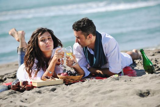 happy young couple enjoying  picnic on the beach and have good time on summer vacations