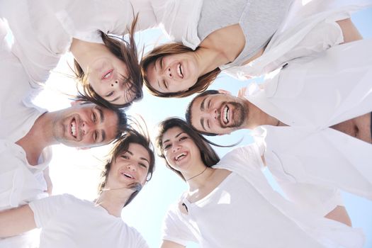 Group of happy young people in circle at beach have fun