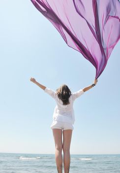 beautiful young woman on beach with scarf relax smile and have fun