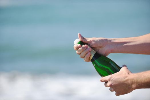 man hands open bottle of champagne alcohol and wine drink outdoor on party celebration event 