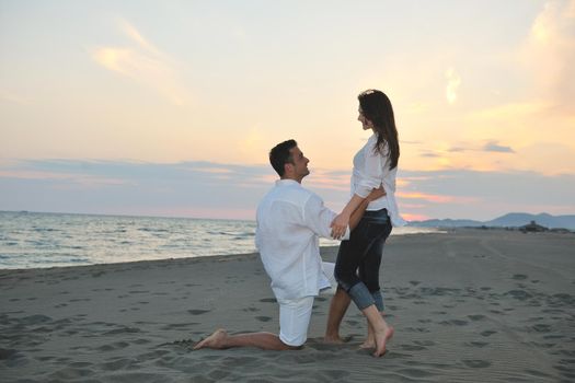 happy young couple have fun and romantic moments on beach at summer season and representing happynes and travel concept