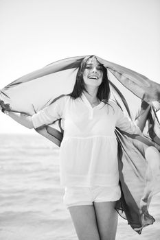 happy young woman relax on beautiful  beach at fresh summer morning and enjoy first ray of sun