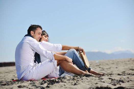 happy young couple enjoying  picnic on the beach and have good time on summer vacations