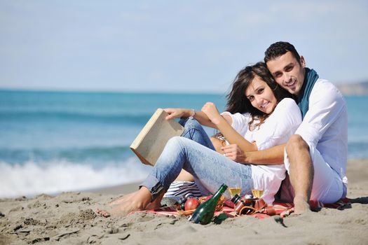 happy young couple enjoying  picnic on the beach and have good time on summer vacations