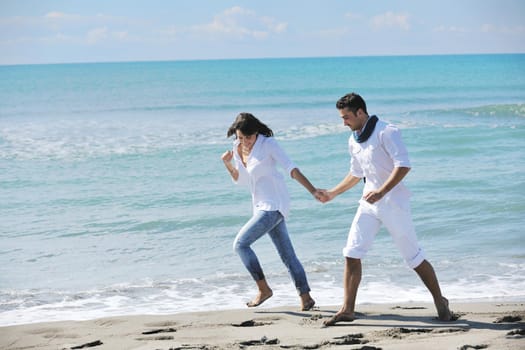 happy young couple in white clothing  have romantic recreation and   fun at beautiful beach on  vacations