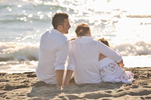 happy young family in white clothing have fun at vacations on beautiful beach 