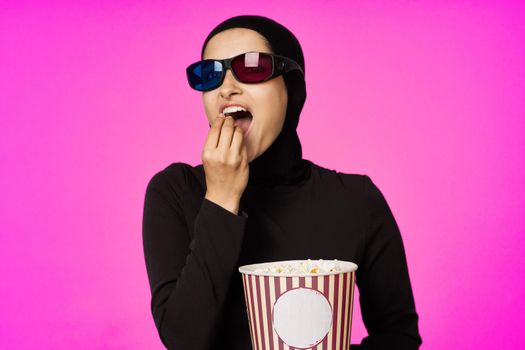 arab woman entertainment cinema popcorn fashion purple background. High quality photo