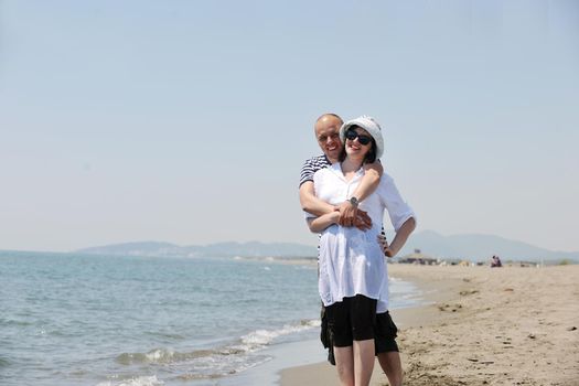 happy young couple have fun and romantic moments on beach at summer season and representing happynes and travel concept