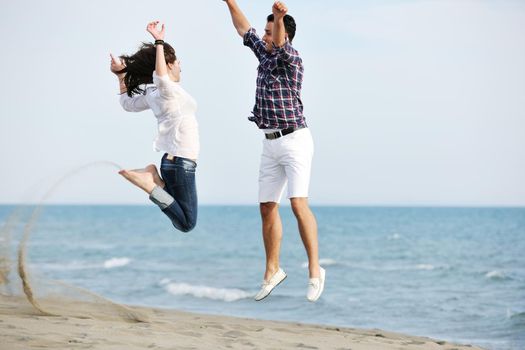 happy young couple have fun and romantic moments on beach at summer season and representing happynes and travel concept