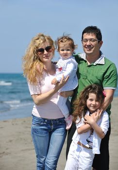 happy young family have fun and live healthy lifestyle on beach