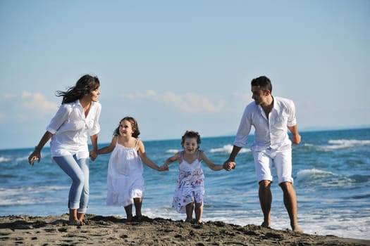 happy young family in white clothing have fun at vacations on beautiful beach 