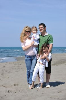 happy young family have fun and live healthy lifestyle on beach