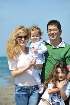 happy young family have fun and live healthy lifestyle on beach