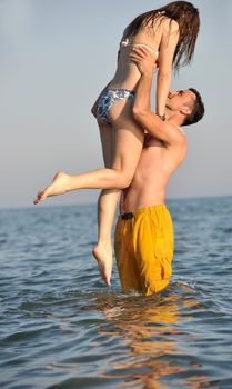 happy young couple have fun and romantic moments on beach at summer season and representing happynes and travel concept