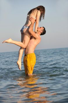 happy young couple have fun and romantic moments on beach at summer season and representing happynes and travel concept