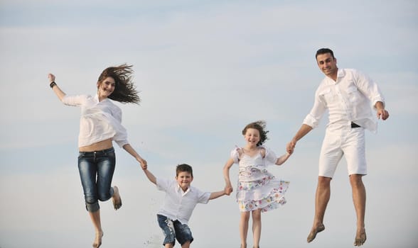 happy young family have fun and live healthy lifestyle on beach