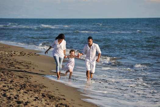 happy young family in white clothing have fun at vacations on beautiful beach 